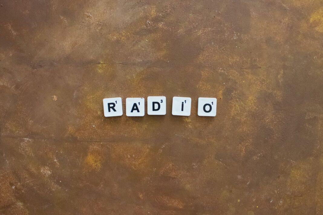 Płytki Scrabble układające słowo Radio na rustykalnym tle Płytki Scrabble układające słowo Radio na rustykalnym tle